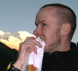 Ian Mills Mountain Bike Guide in Chamonix. Eating a burger infront of Mont Blanc